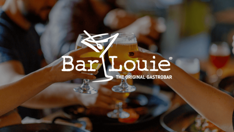 Two people clinking glasses of beer at a bar with an overlay of the Bar Louie logo.