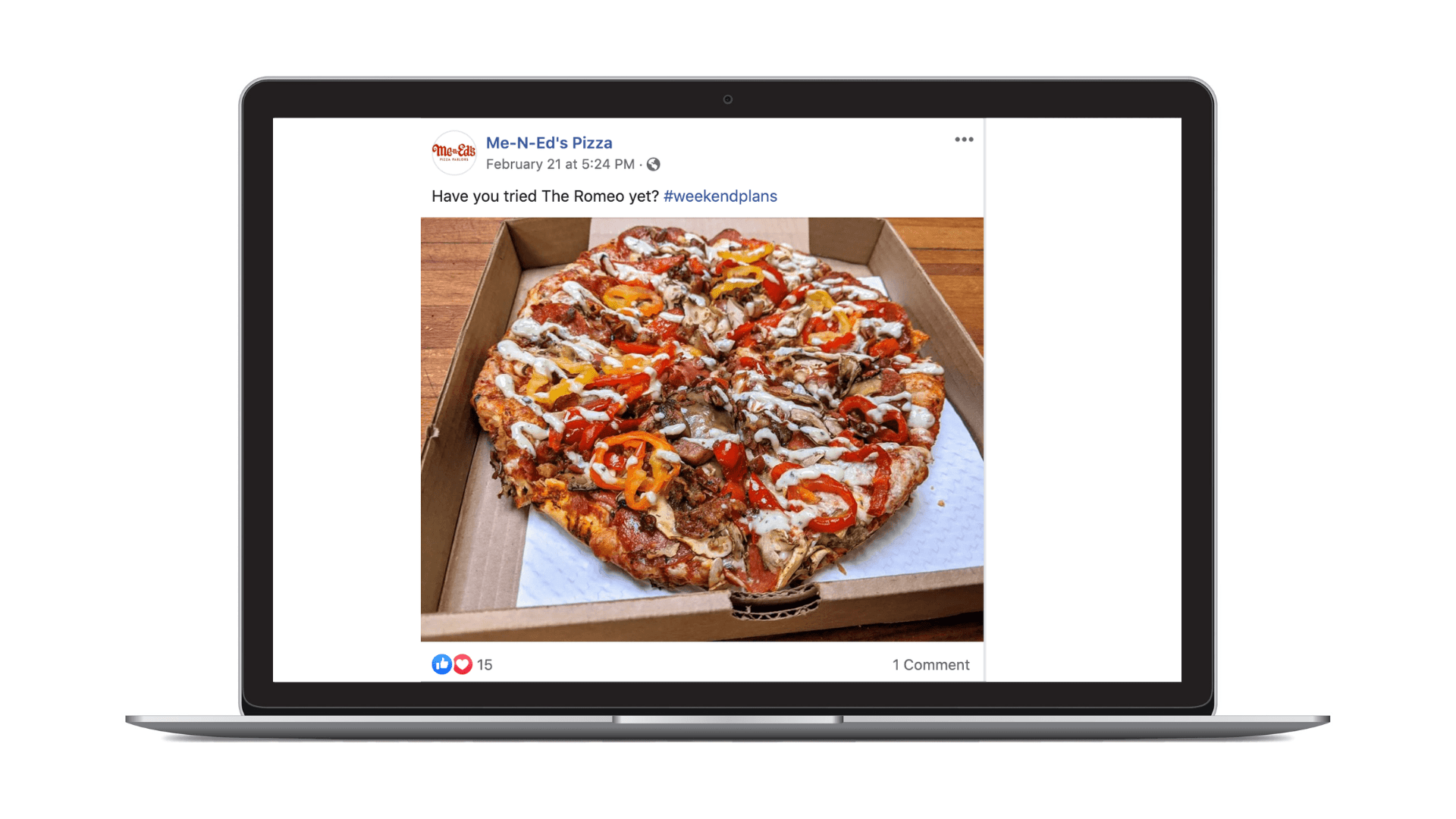 A loaded pizza with various meats, peppers, and drizzled sauce in an open box, shown on a laptop screen.