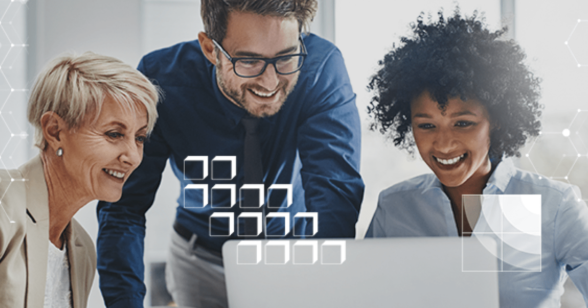 An image of three people around a laptop