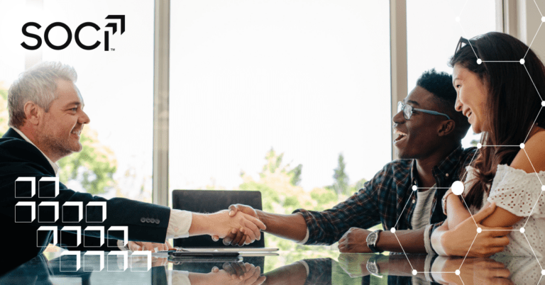 Three people smiling and shaking hands at a table in a bright office, with “SOC” and tech graphics overlay.