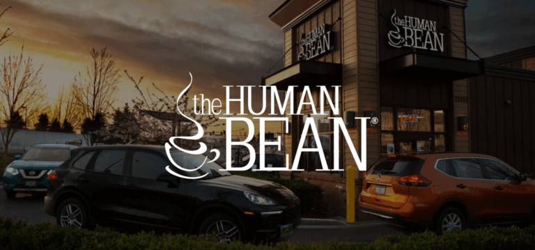 Cars in a drive-thru at The Human Bean coffee shop at sunset, with the logo overlaid on the image.
