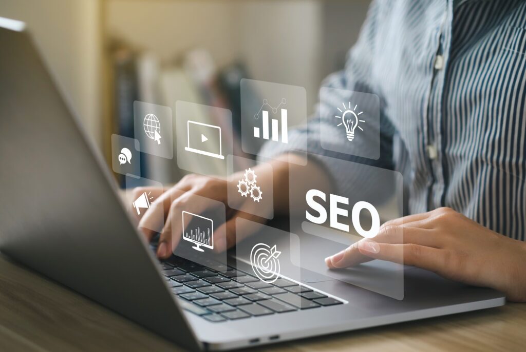 A person typing on a laptop with SEO icons including graphs, a light bulb, and a target, overlayed above.