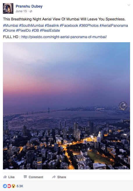 Aerial view of Mumbai at night, showcasing illuminated buildings and coastline under a twilight sky.