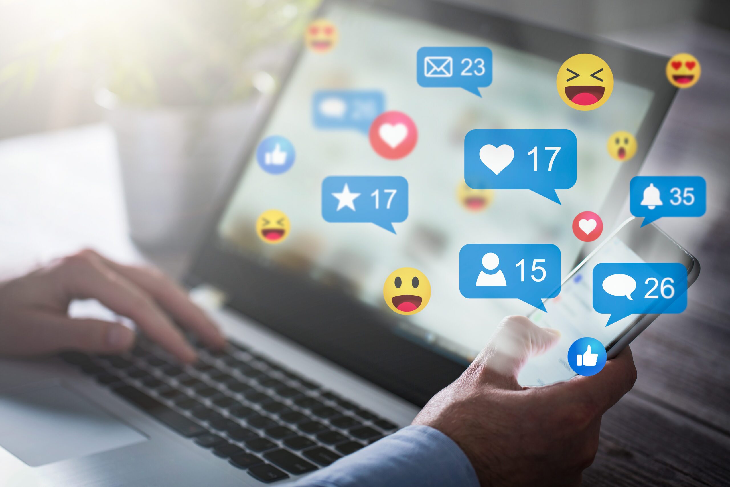 A person using a laptop and smartphone with an overlay of social likes.